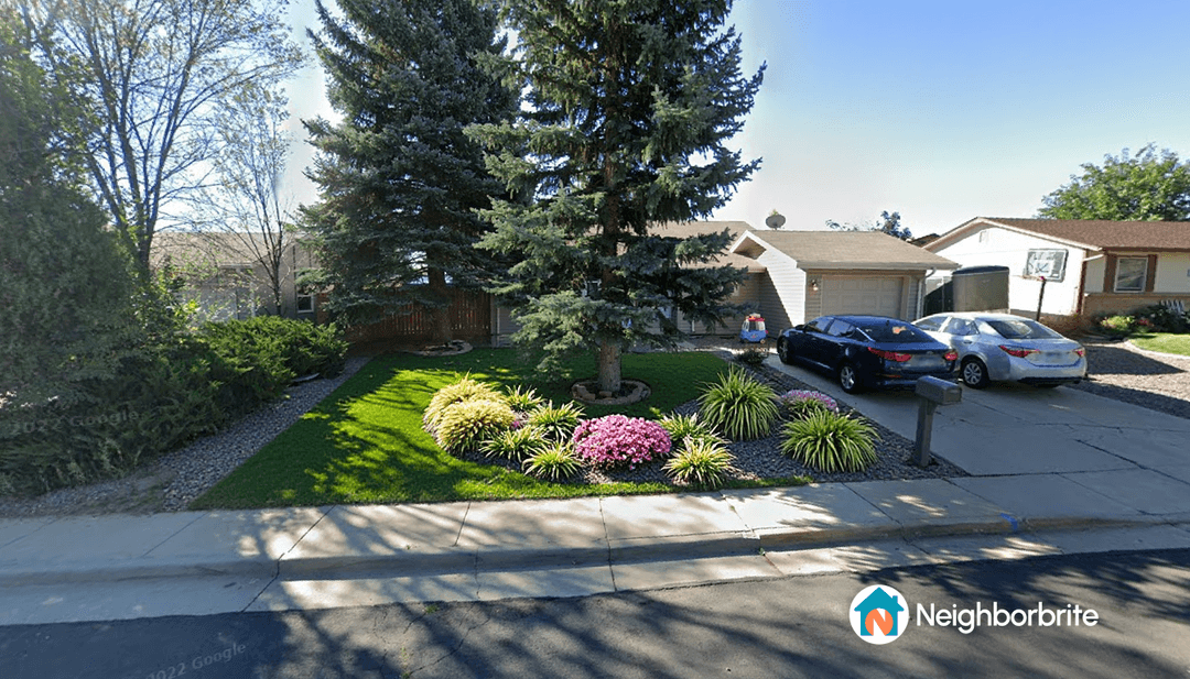 A landscaped yard featuring drought-tolerant plants and trees.