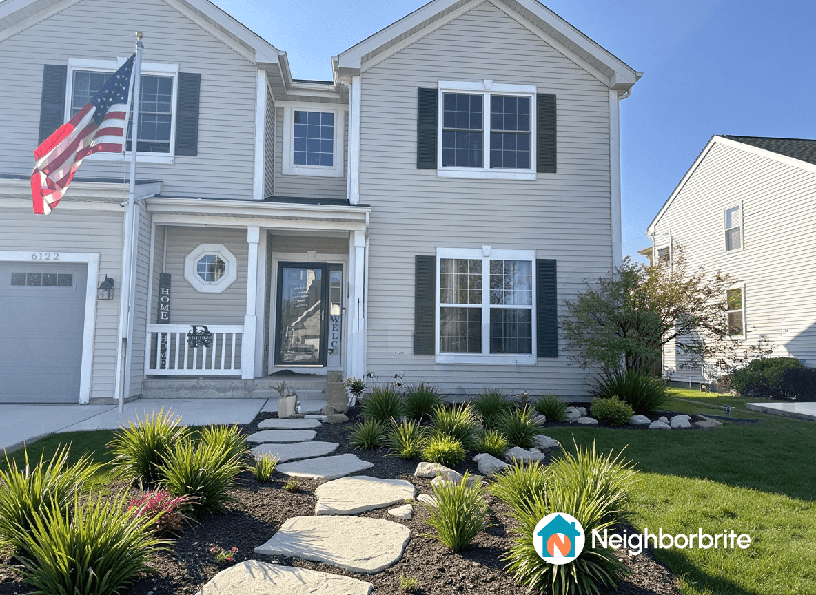 A charming home with a welcoming front yard and pathway.
