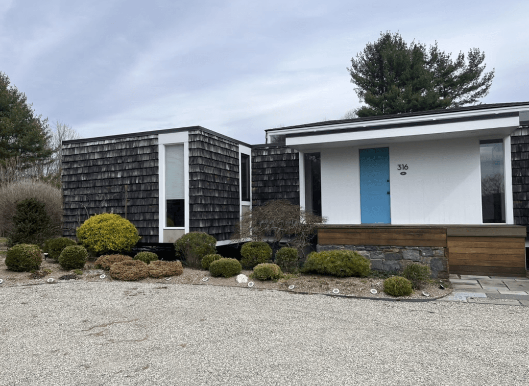 Front garden of a midcentury house with Japanese elements.