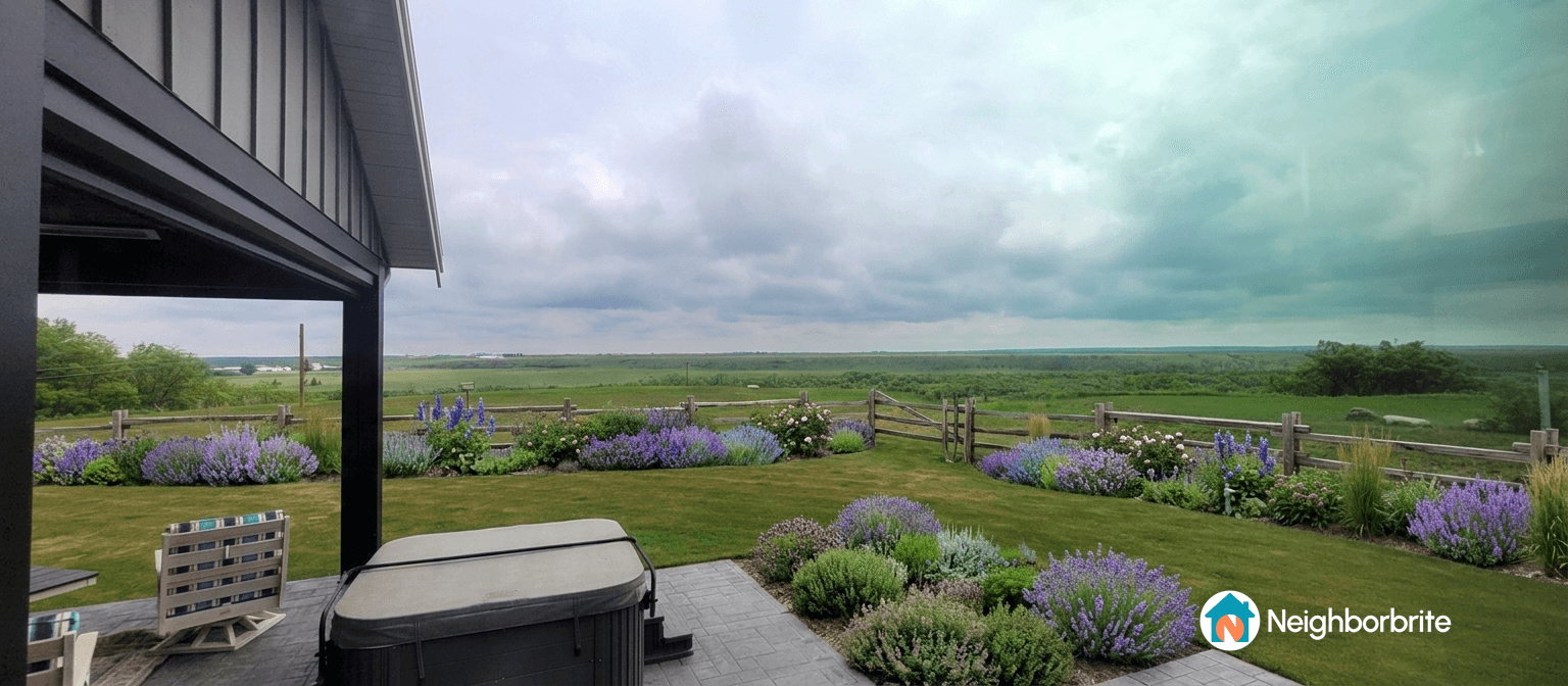 A beautiful landscaped yard with flowers and a view.