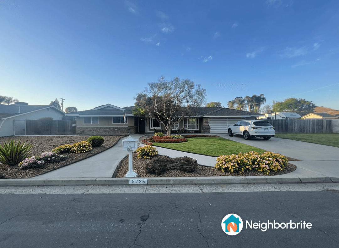 Front yard with flowers and lawn, seeking drought tolerant options.