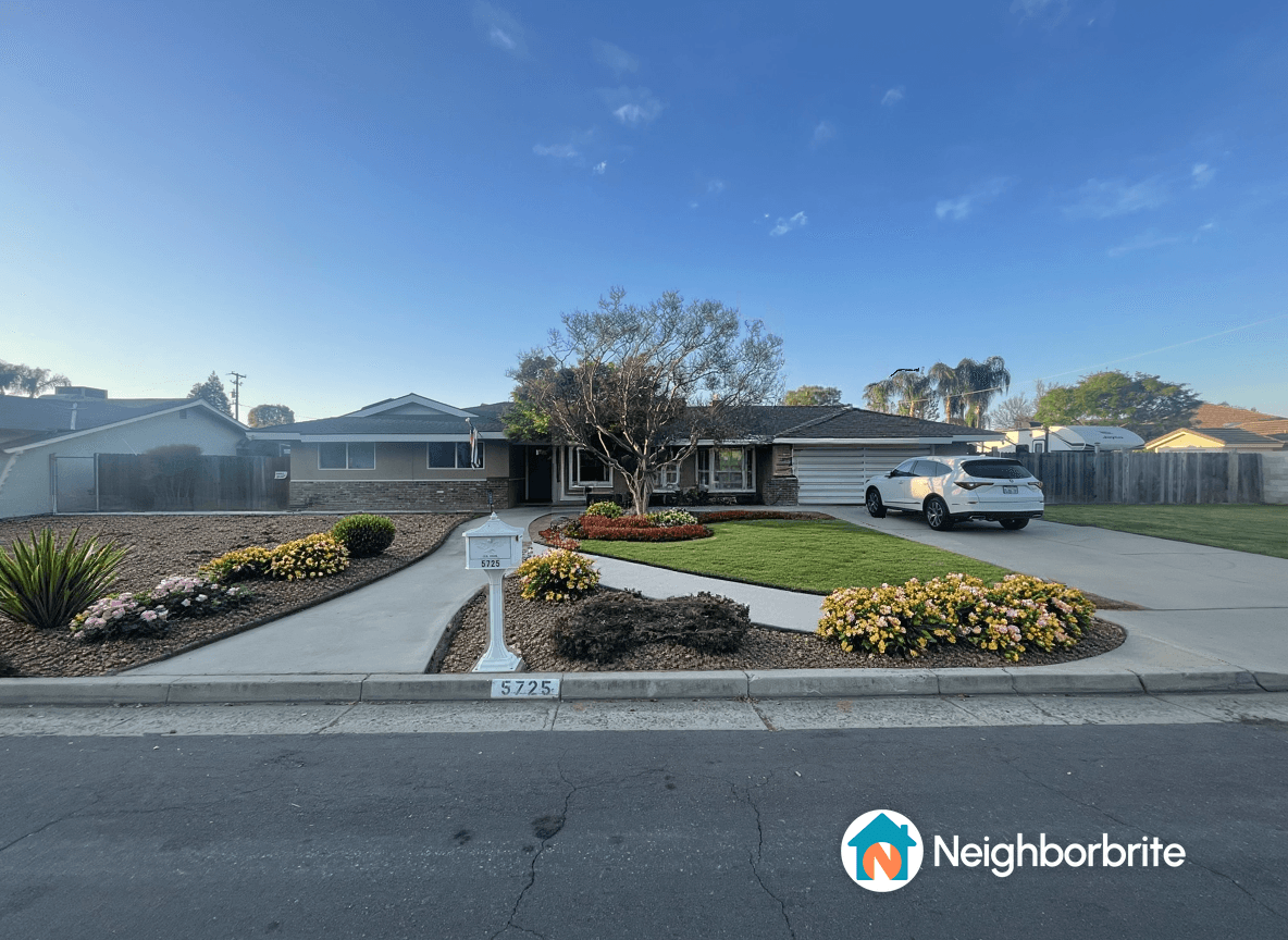 Front yard with flowers and lawn, seeking drought tolerant options.