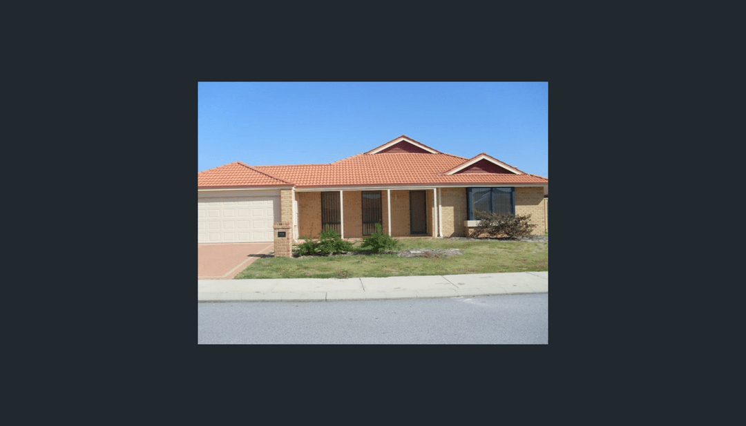 A modern house with a landscaped front yard and driveway.