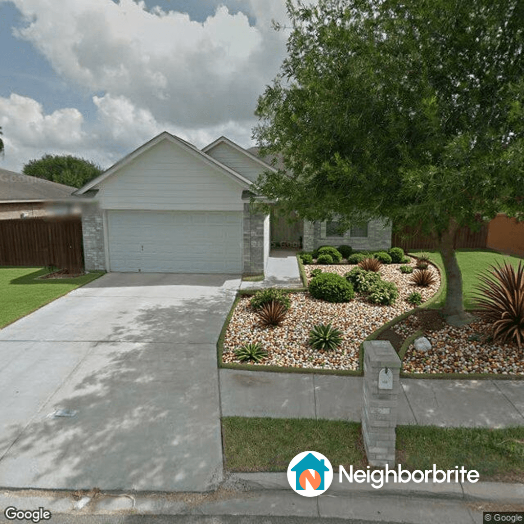 Front yard landscaping with drought-tolerant plants and stones.