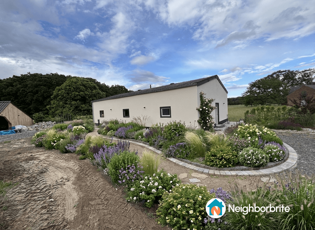 A beautiful garden with colorful flowers surrounding a modern house in Walbeck.