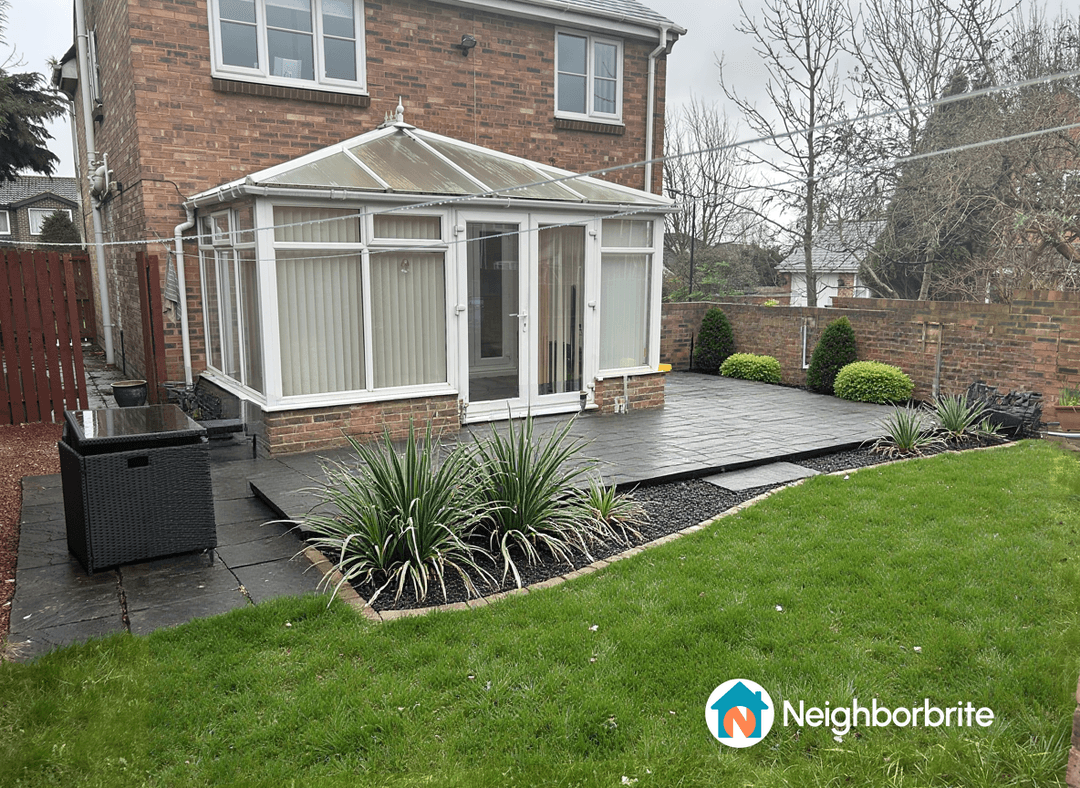 A garden featuring a seating area, low maintenance plants, and patio.