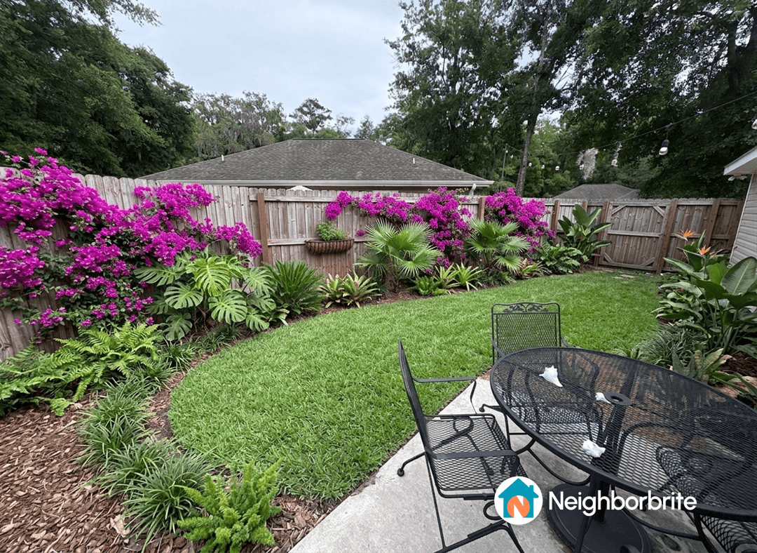 A vibrant garden with purple flowers and lush greenery.