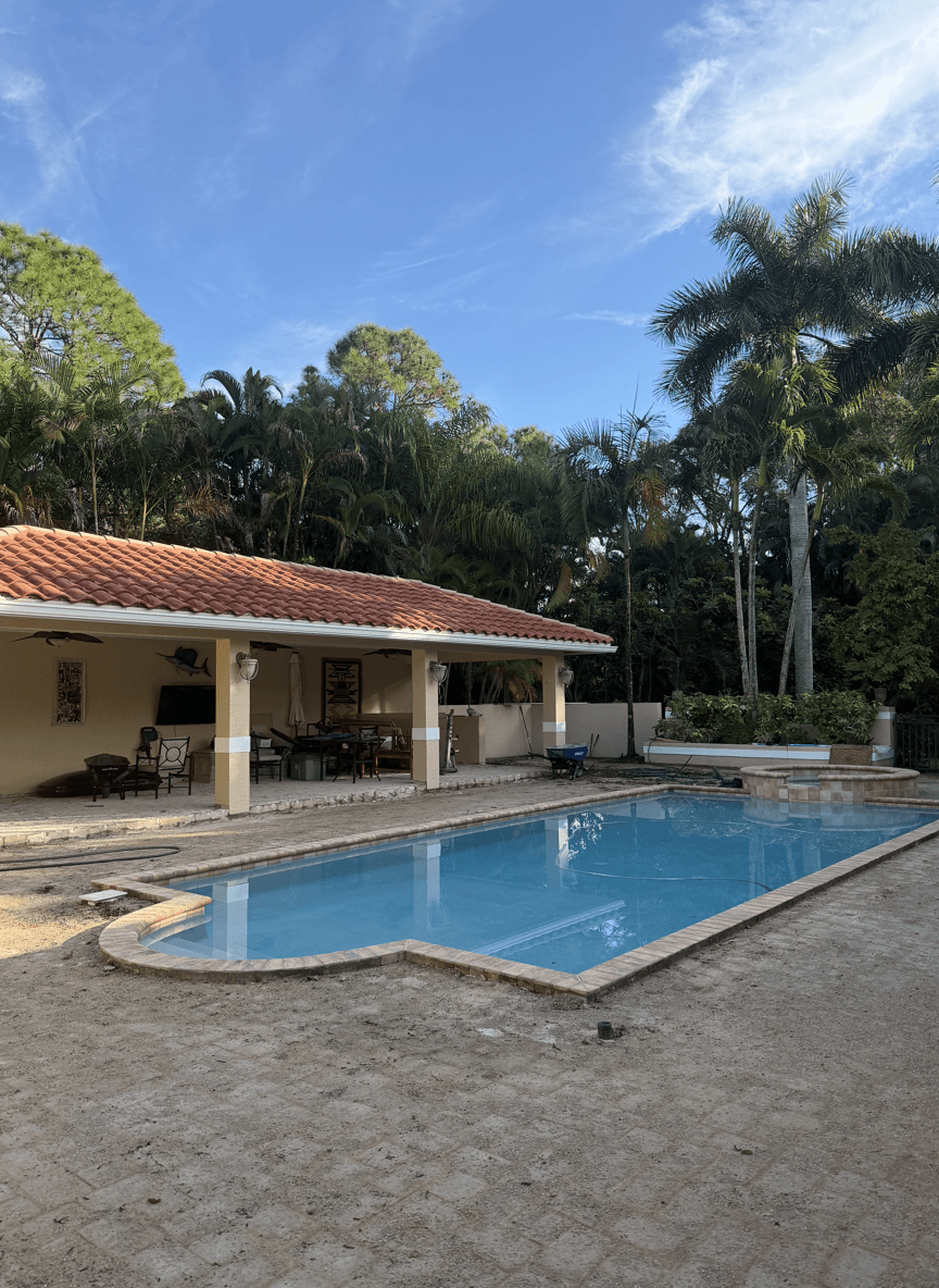 Patio under remodeling with pool and jacuzzi area.