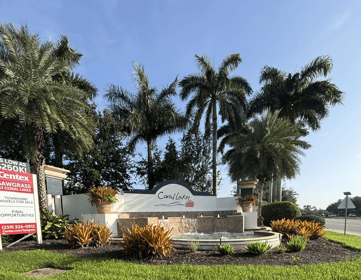 Fountain surrounded by palm trees and landscaping at Coral Lakes.