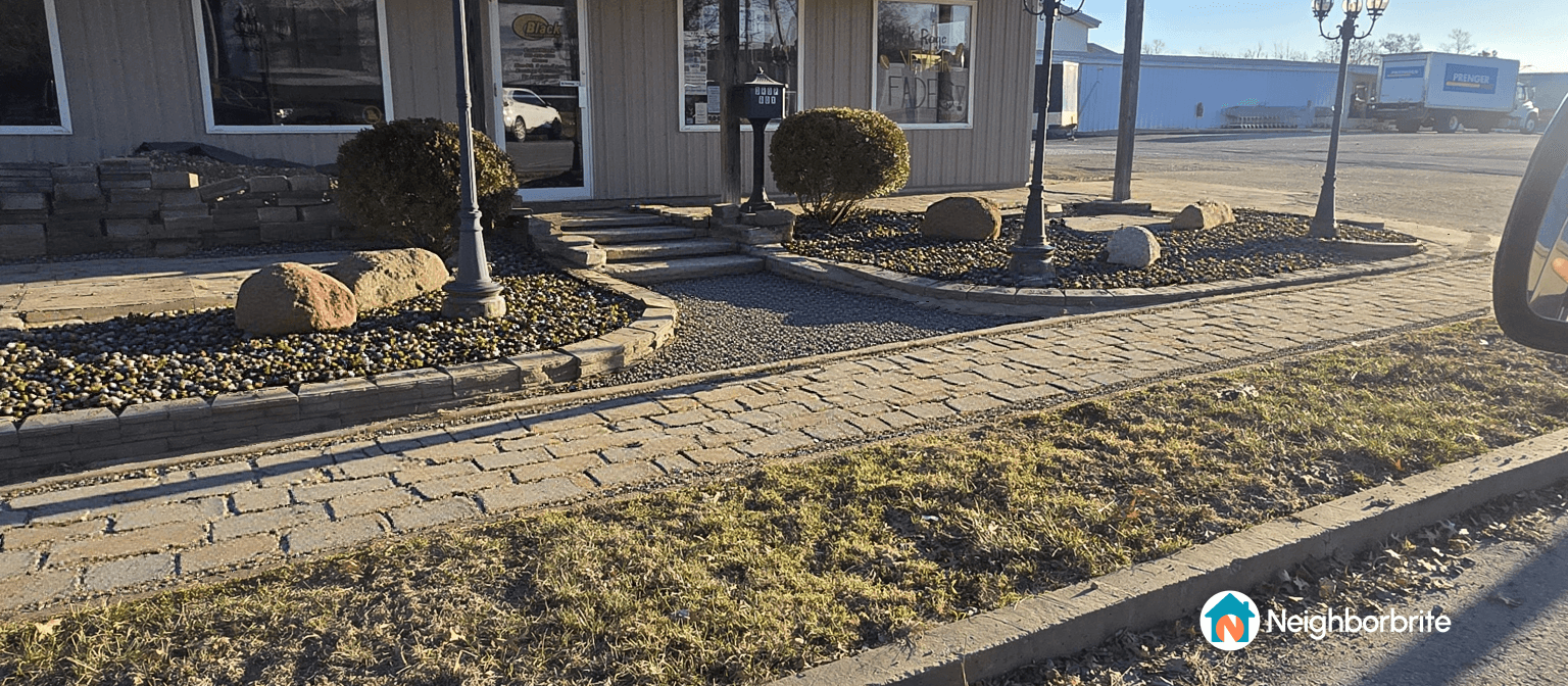 A well-designed business entrance with stone pathways and landscaping.