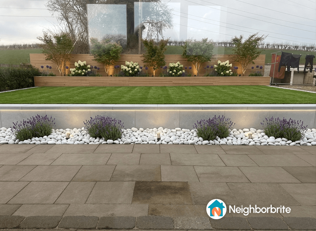 A landscaped yard featuring a slatted planter, lavender, and box hedge.