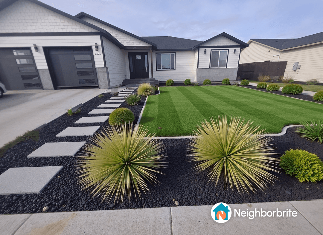 A well-designed front yard with green grass, stone pathways, and decorative plants.