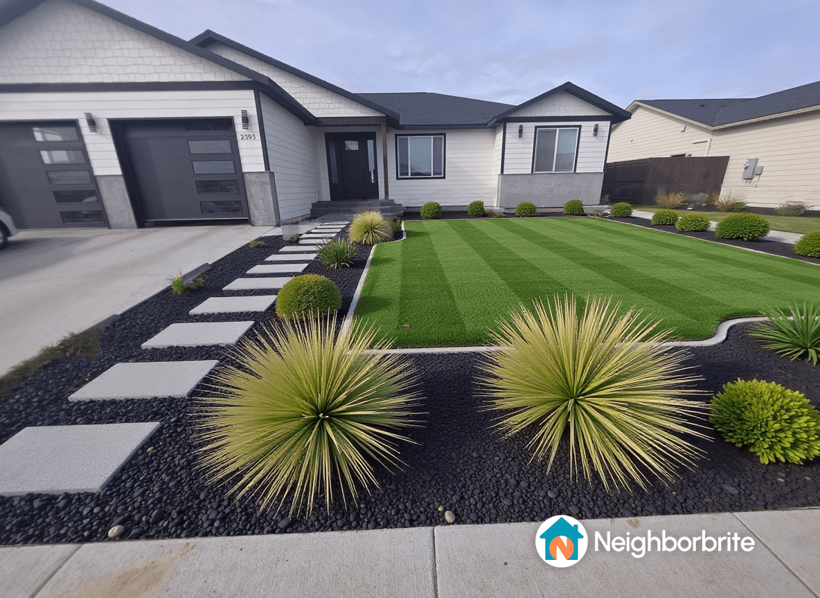 A well-designed front yard with green grass, stone pathways, and decorative plants.
