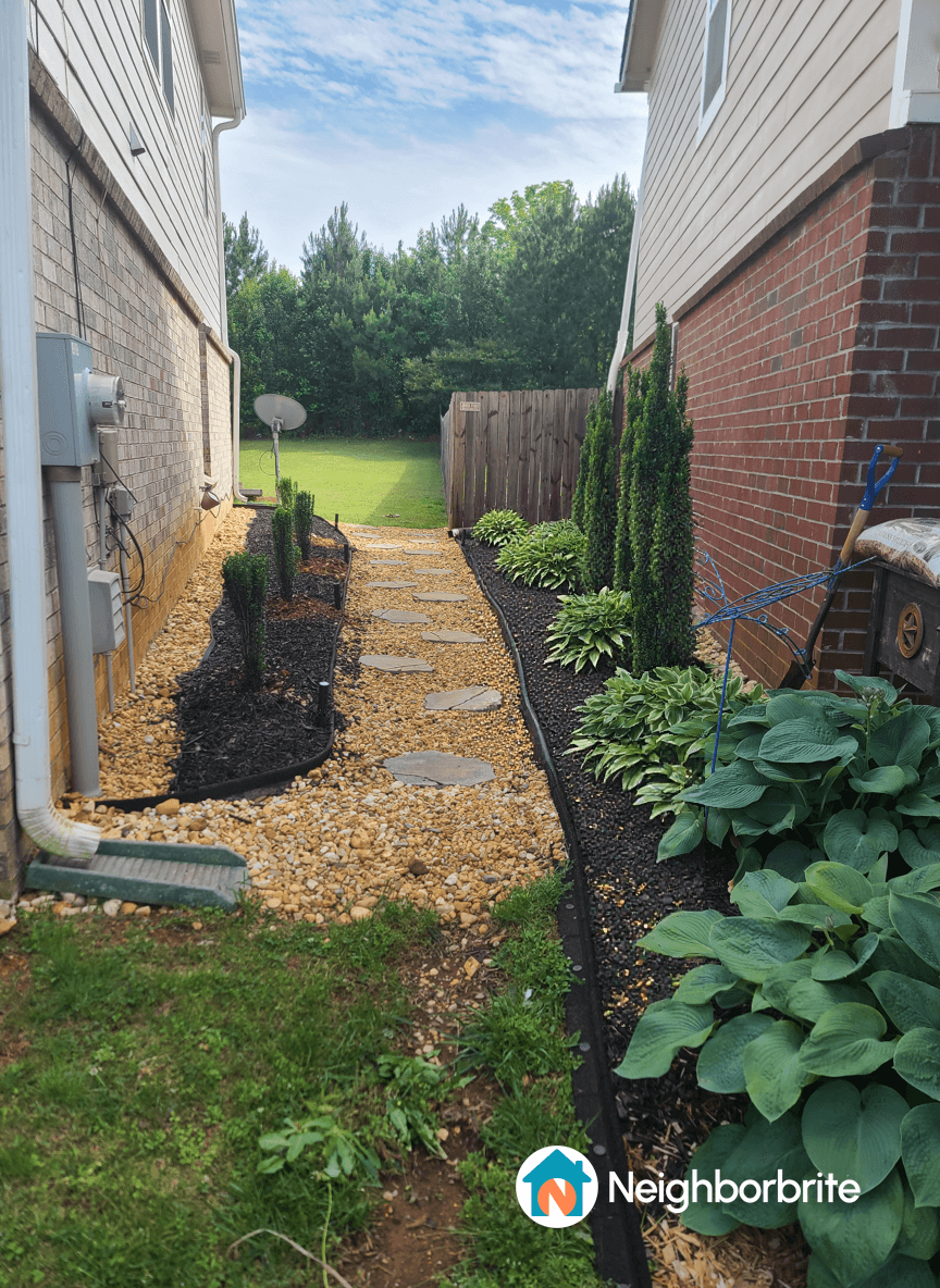 Garden path with hostas and sun exposure on one side.
