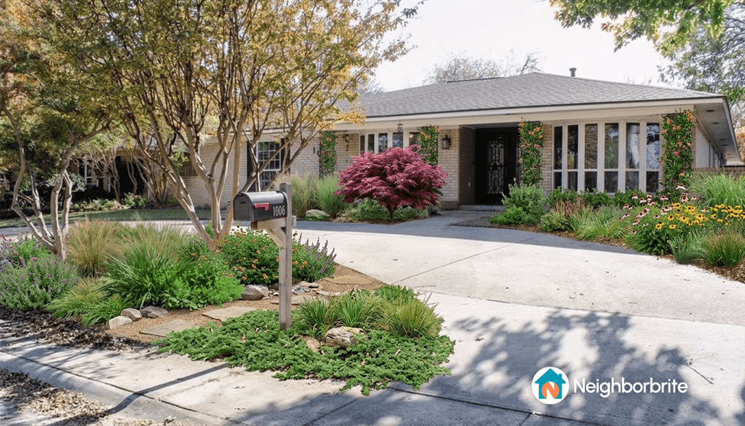 Beautifully landscaped front yard with flowers and trees.
