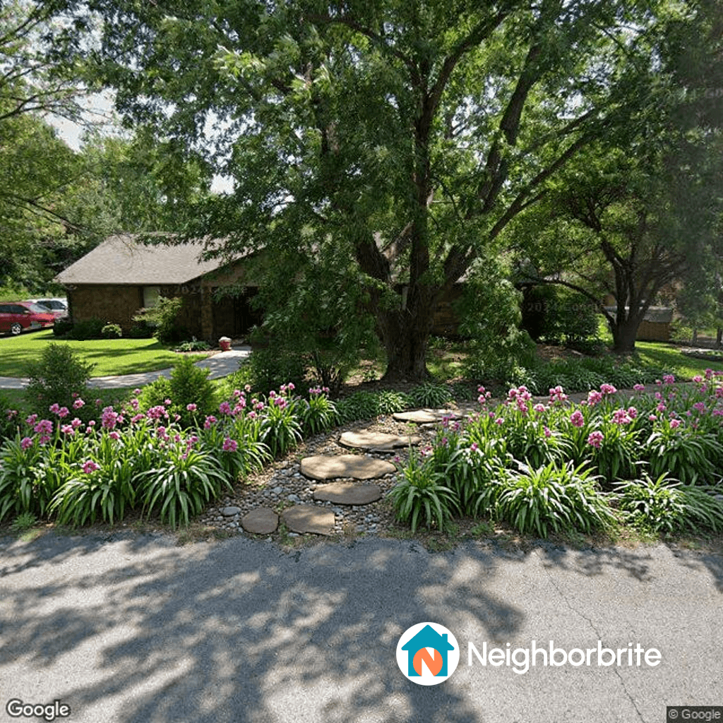 A landscaped yard with stone path and flowers.