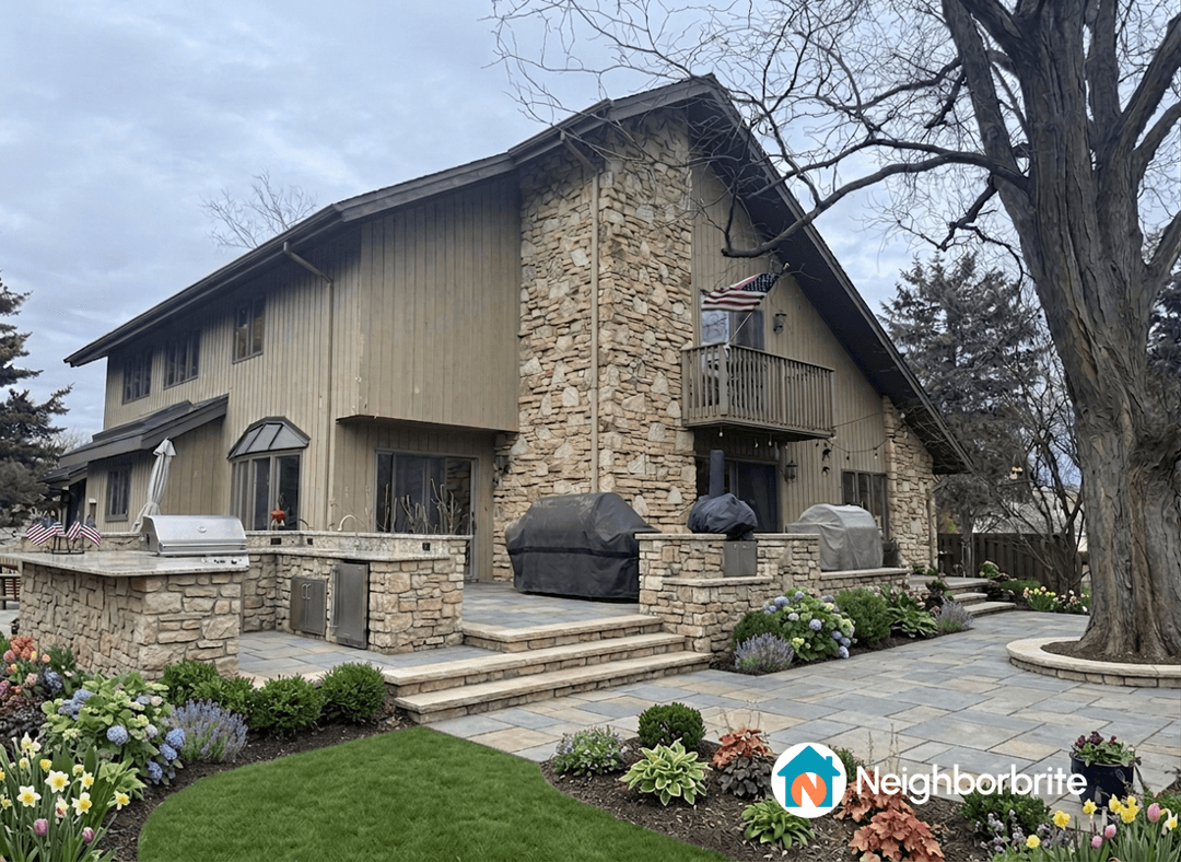 A landscaped yard with stone features and greenery.