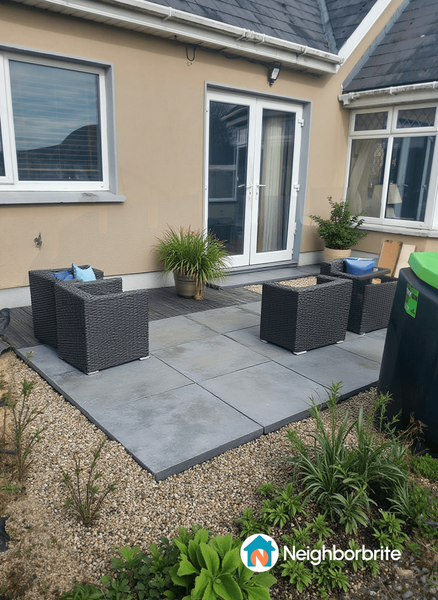 A patio area with two chairs, plants, and a door, seeking cost estimate.