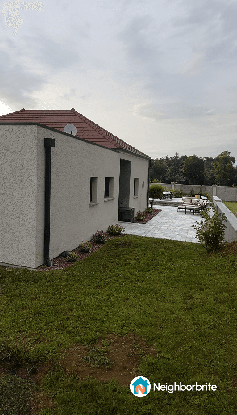 View of a house with a patio and garden area, seeking plant ideas.
