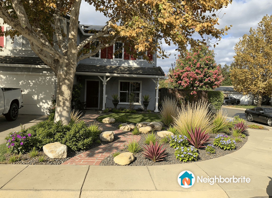 Beautiful front yard landscaping with plants and stones.