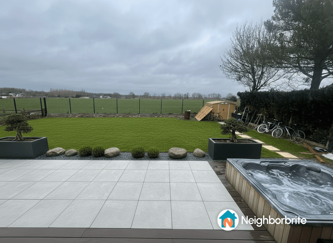 View of a patio with potential for a pergola and hedges.